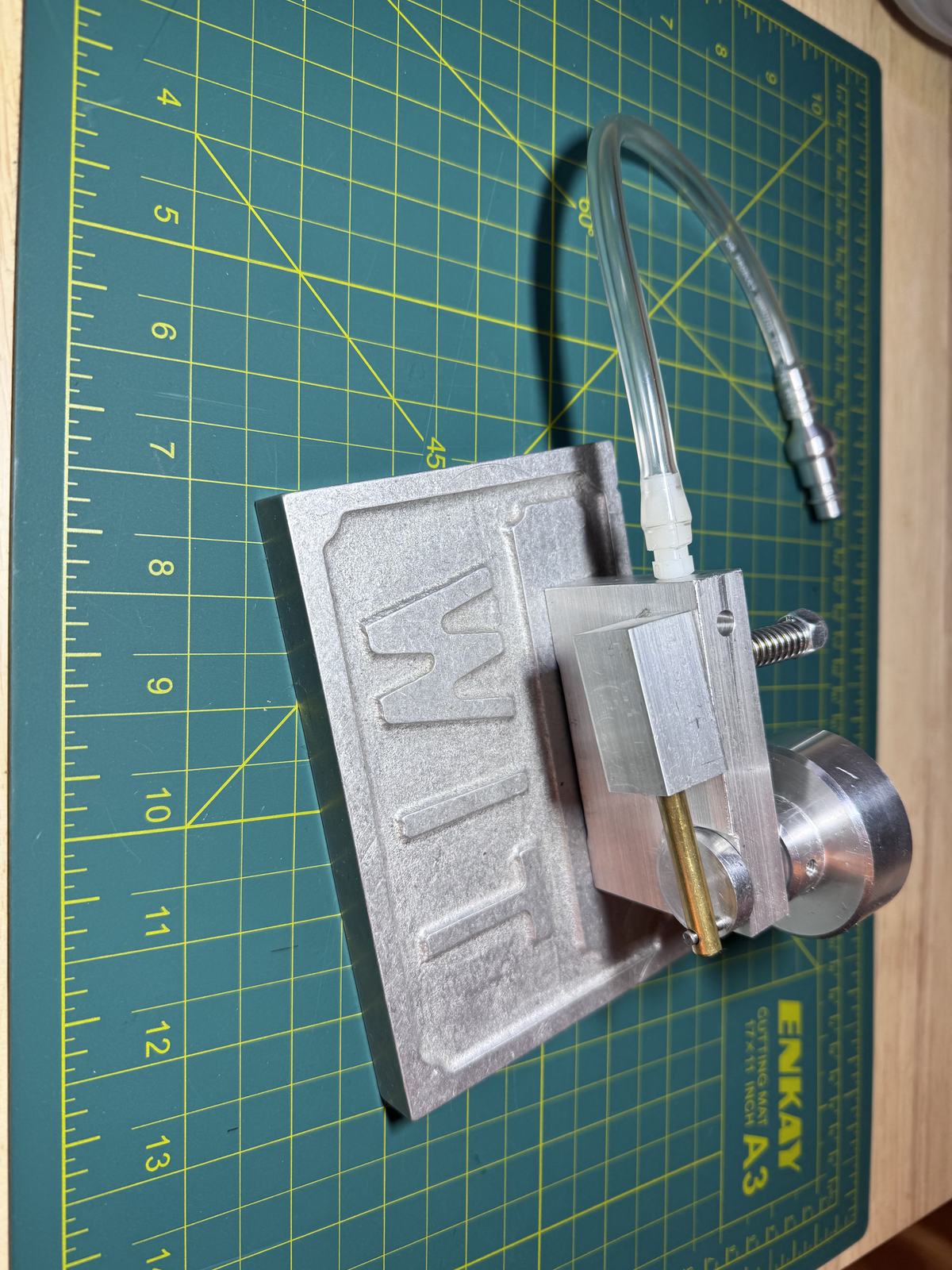 Fully assembled wobbler engine on its machined aluminum base plate with air hose attached